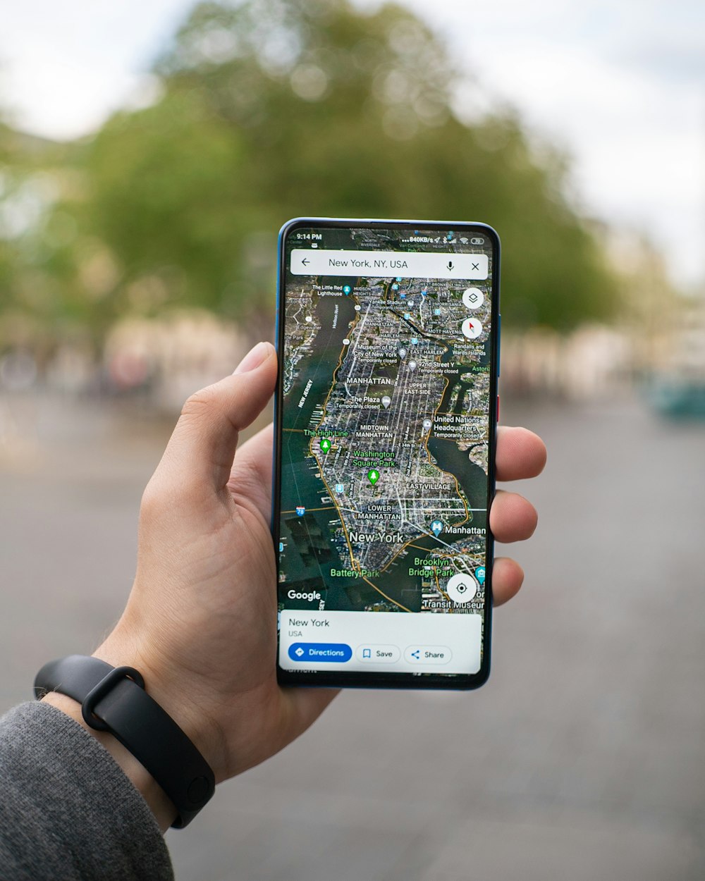 A phone showing a map on a street