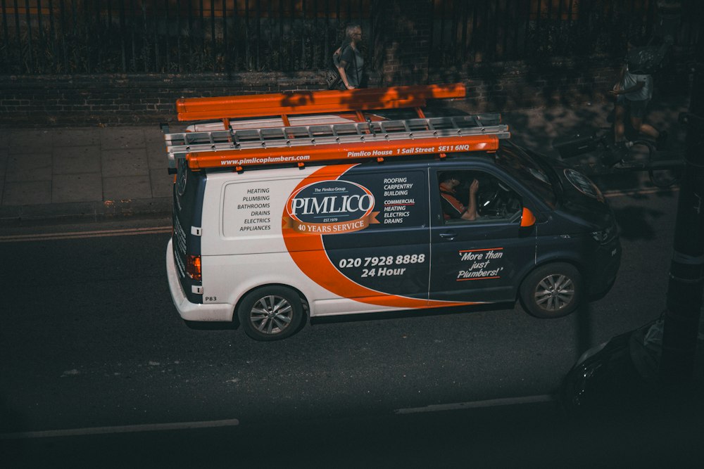 A trades van parked on a city street at night