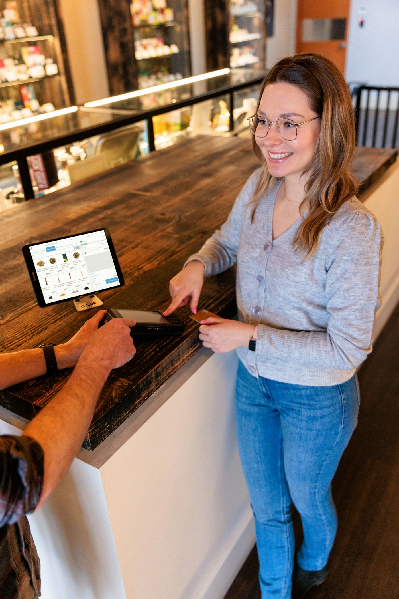 A smiling shop owner at her counter